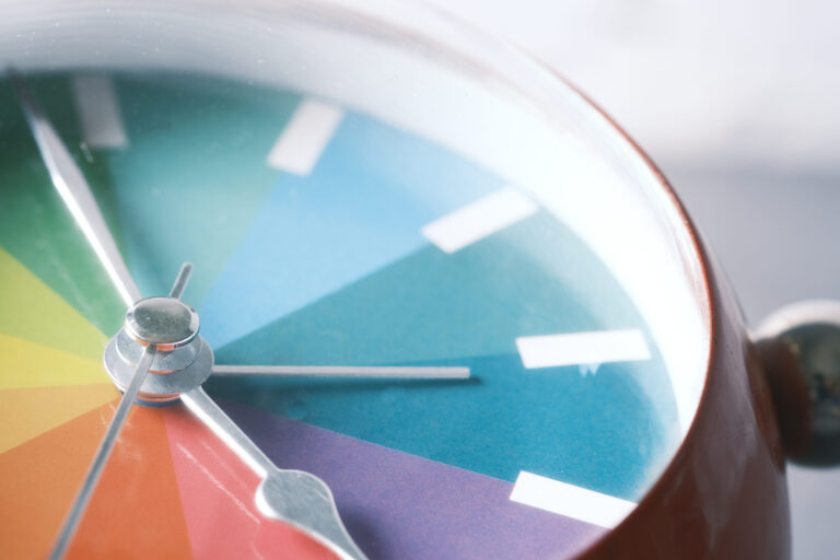 detail shot of colorful old alarm clock on color background
